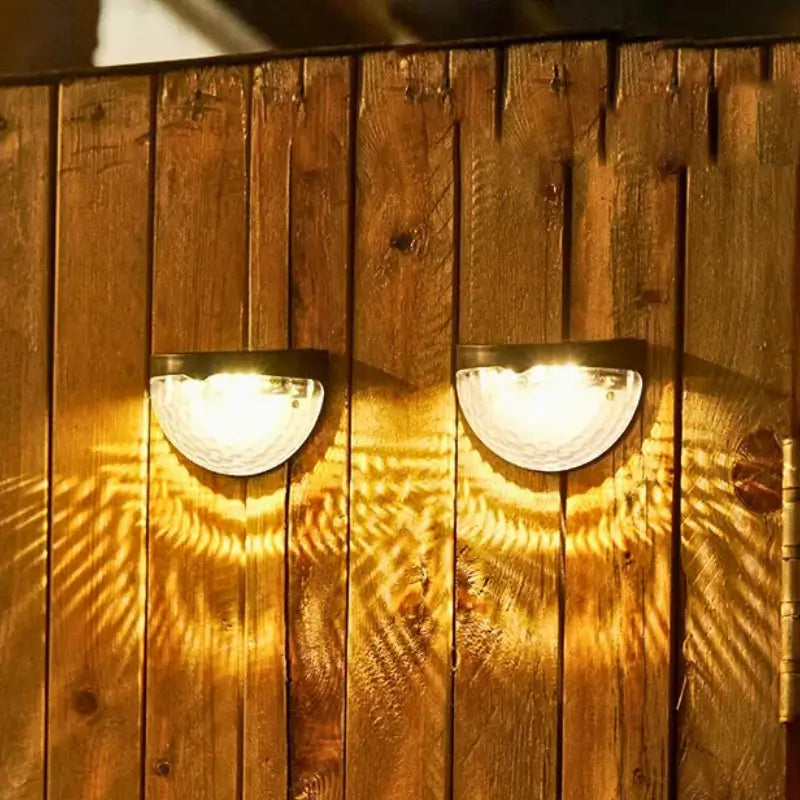 Two wall-mounted lights on a wooden panel with warm glow